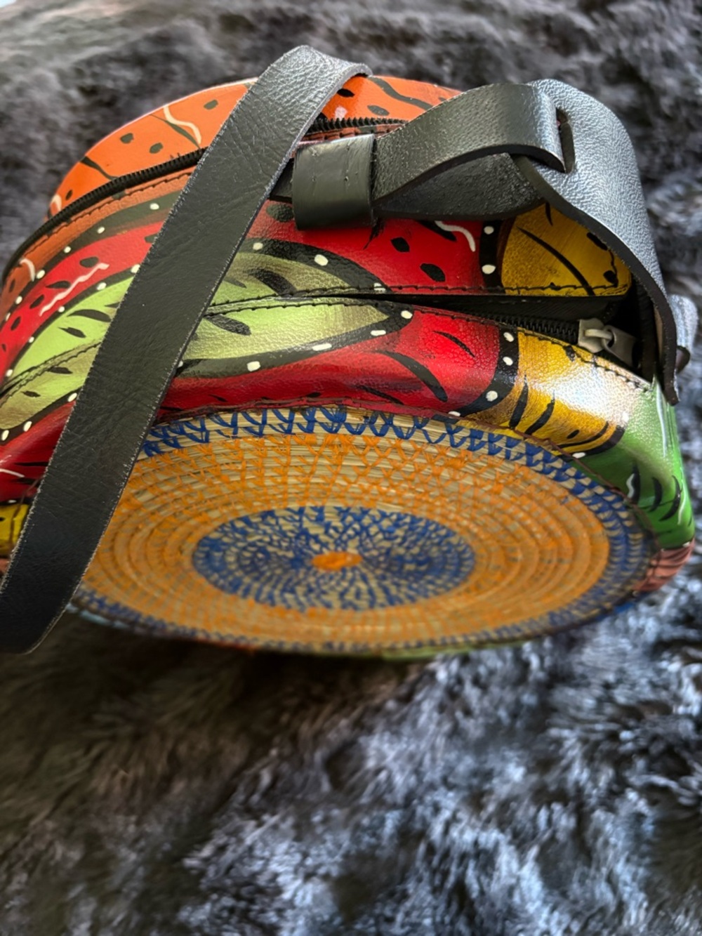 Hand-Painted Round Crossbody Bag with long strap.